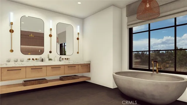 a bathroom with a tub and a double vanity sink