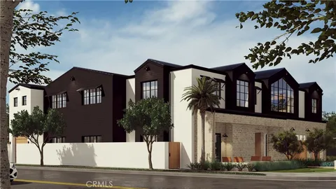 a front view of a house with a tree