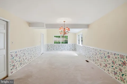 a view of a room with window and chandelier