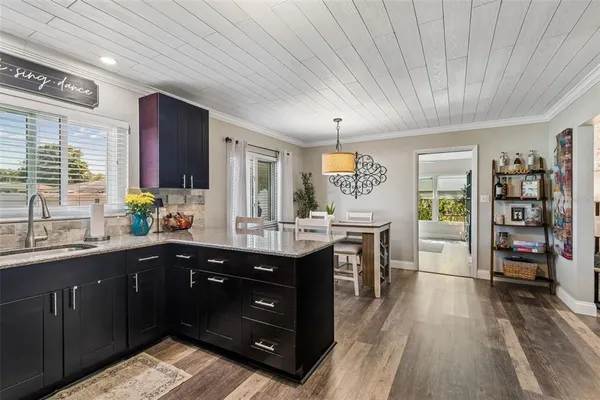 a kitchen with stainless steel appliances granite countertop a sink and wooden cabinets