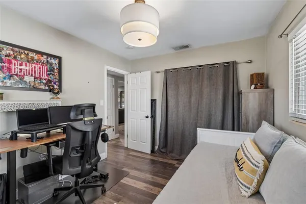 a view of a livingroom with workspace and a window