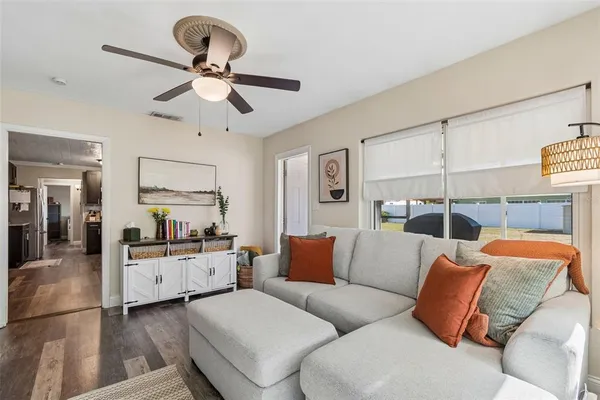 a living room with furniture and kitchen view