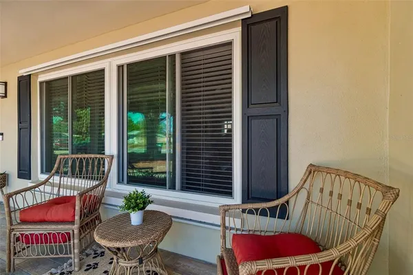 a balcony with furniture and wooden floor