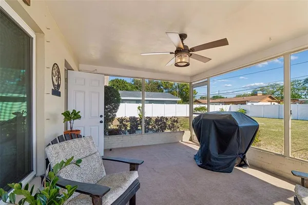 a living room with furniture and a floor to ceiling window