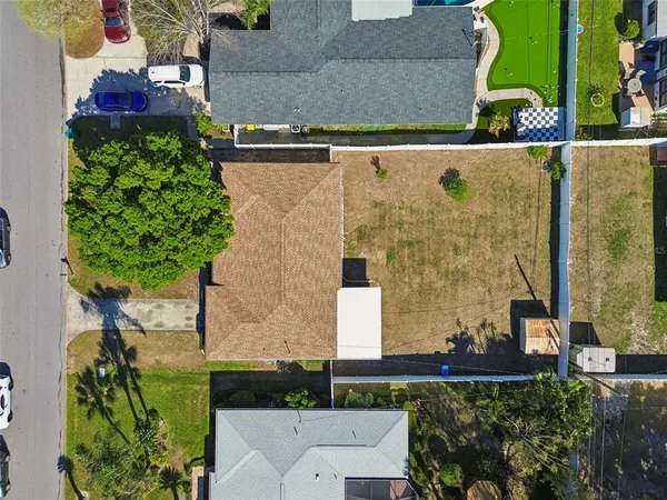 an aerial view of residential houses with outdoor space and street view