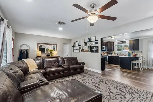 a living room with furniture and kitchen view