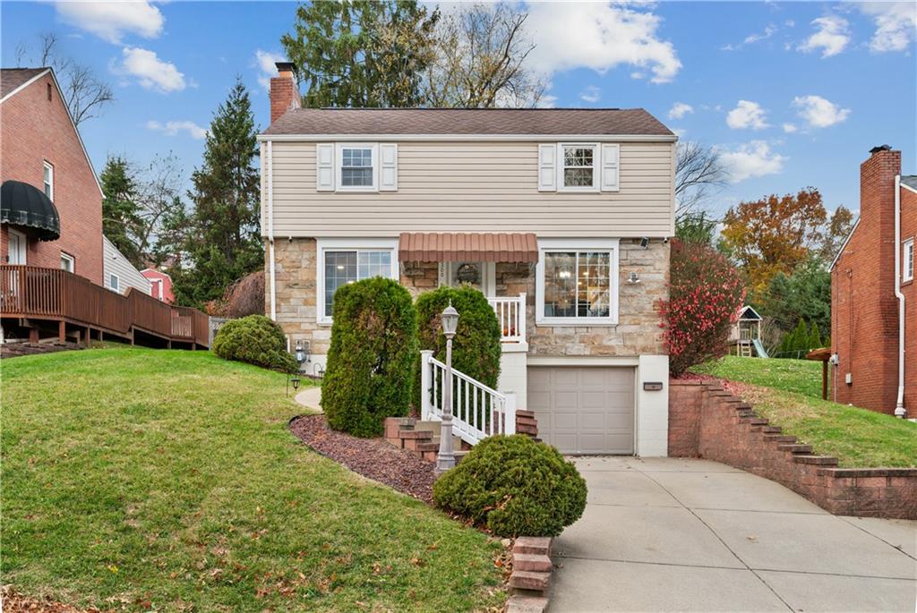 a front view of a house with a garden
