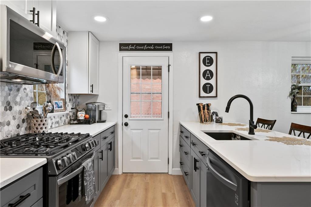 5300 Spring Valley Drive Pittsburgh, PA 15236 - Photo 11 of 25 a kitchen with stainless steel appliances granite countertop a sink stove and cabinets