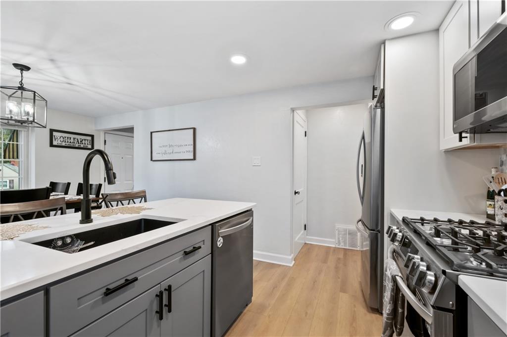 5300 Spring Valley Drive Pittsburgh, PA 15236 - Photo 12 of 25 a kitchen that has a sink and a stove
