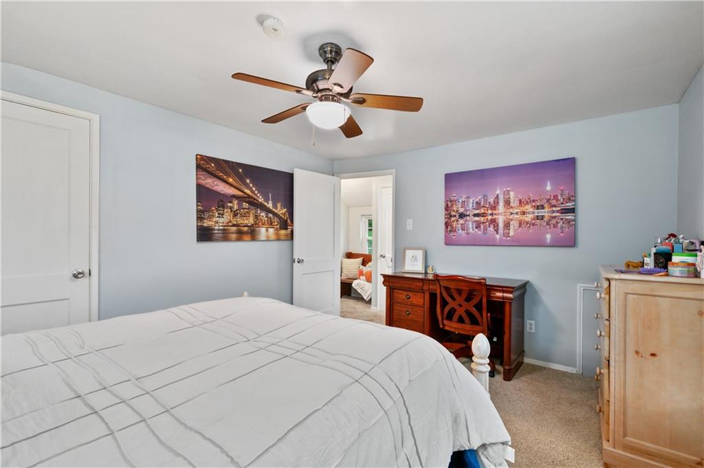 5300 Spring Valley Drive Pittsburgh, PA 15236 - Photo 15 of 25 a bedroom with a large bed and a chandelier