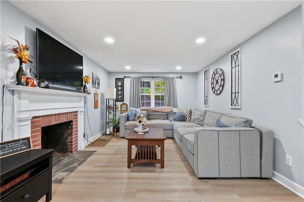 5300 Spring Valley Drive Pittsburgh, PA 15236 - Photo 3 of 25 a living room with furniture a flat screen tv and a fireplace