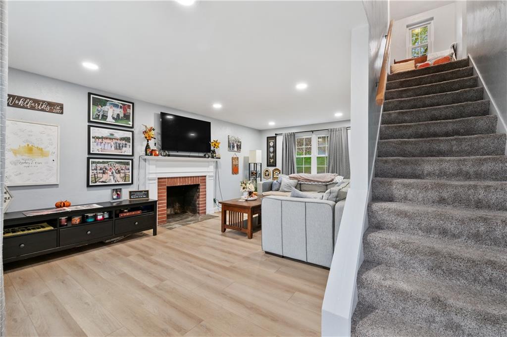 5300 Spring Valley Drive Pittsburgh, PA 15236 - Photo 5 of 25 a living room with furniture a fireplace and a flat screen tv