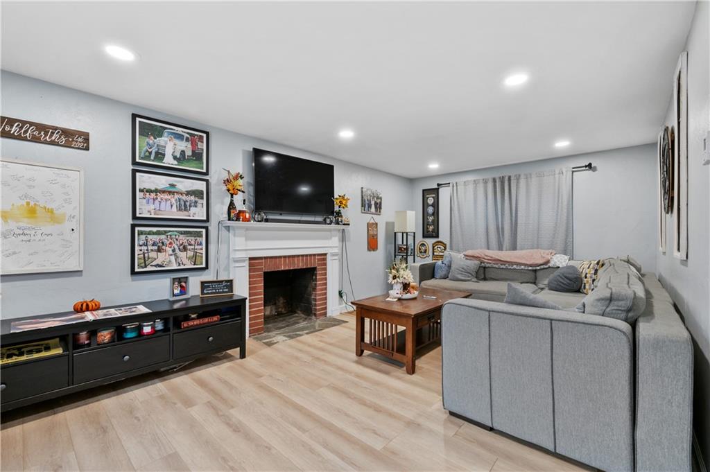 5300 Spring Valley Drive Pittsburgh, PA 15236 - Photo 6 of 25 a living room with furniture a flat screen tv and a fireplace