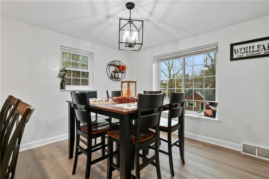 5300 Spring Valley Drive Pittsburgh, PA 15236 - Photo 9 of 25 a view of a dining room with furniture wooden floor and chandelier
