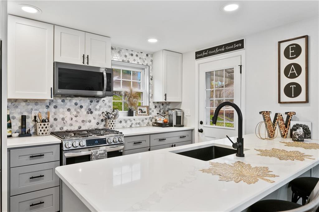 5300 Spring Valley Drive Pittsburgh, PA 15236 - Photo 10 of 25 a kitchen with granite countertop a sink a stove and cabinets