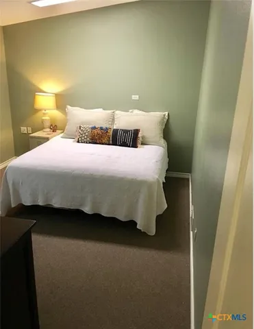 a bedroom with a bed and chair