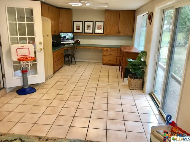 a kitchen with stainless steel appliances kitchen island granite countertop a refrigerator and a sink