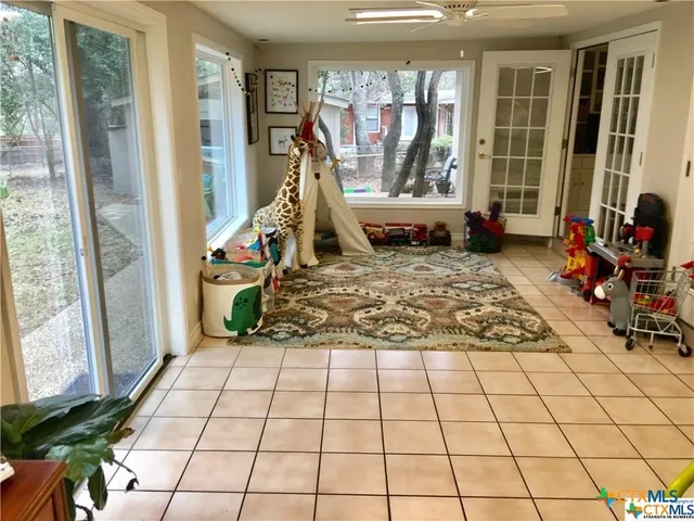 a view of a bedroom with furniture and windows