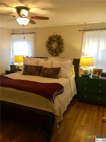 a bedroom with a bed and a lamp