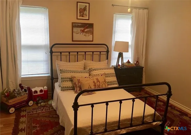 a bedroom with furniture and a window