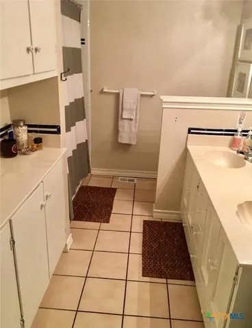 a bathroom with a sink a toilet and mirror