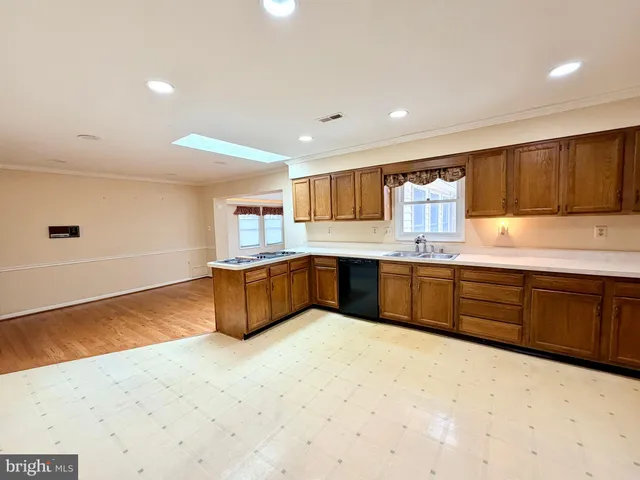 a view of an empty room with a fireplace and wooden floor