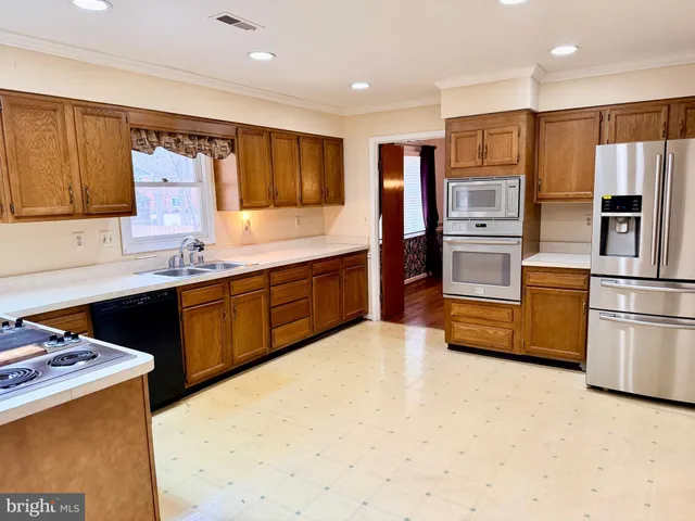 a view of a livingroom with wooden floor and a fireplace