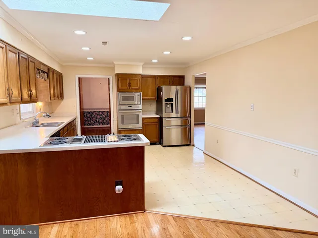 a view of a hallway with wooden floor and stairs