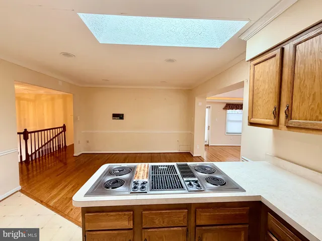 a view of an empty room with wooden floor and a floor to ceiling window