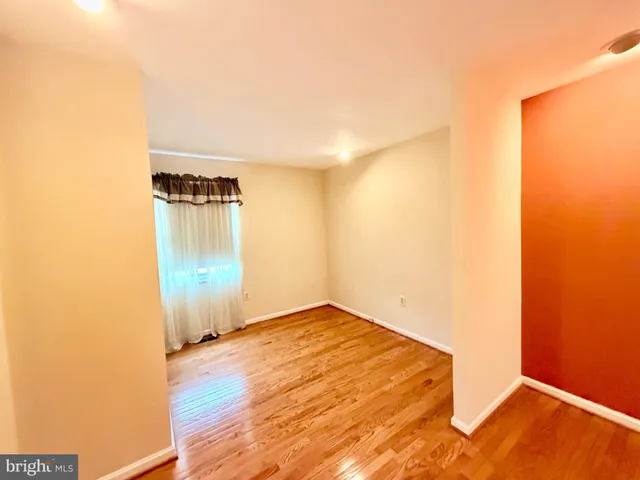 a view of a storage & utility room with refrigerator and washer