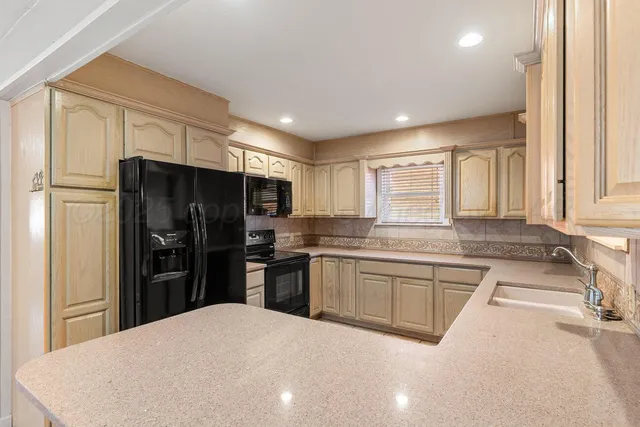 a kitchen with a sink stainless steel appliances and cabinets