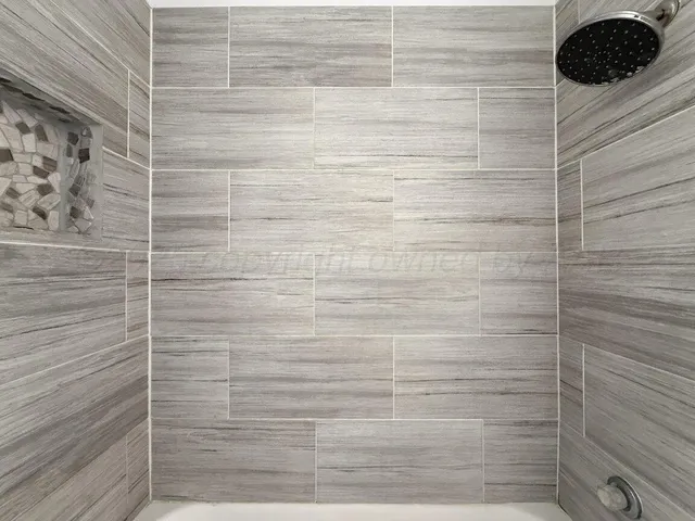 a view of an empty room with a ceiling fan