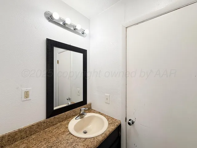 a bedroom with bed and painting on the wall