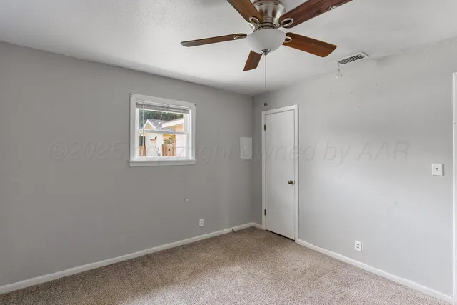 a view of empty room with stairs and wooden floor