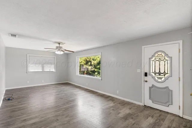 an empty room with windows and closet