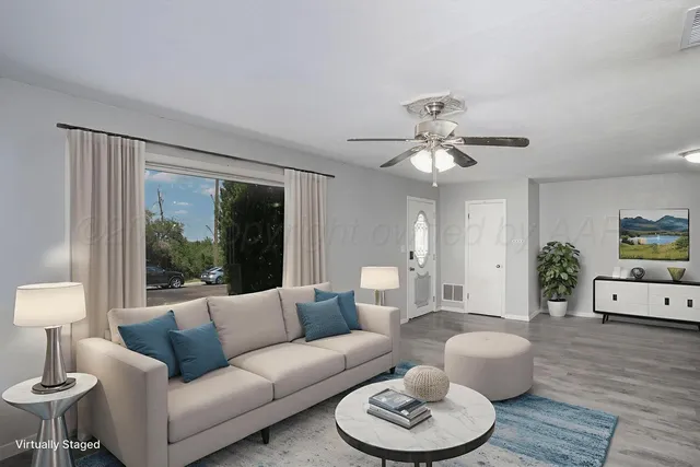 a living room with furniture and a large window