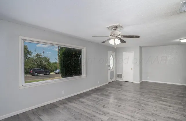 a view of an empty room with a window