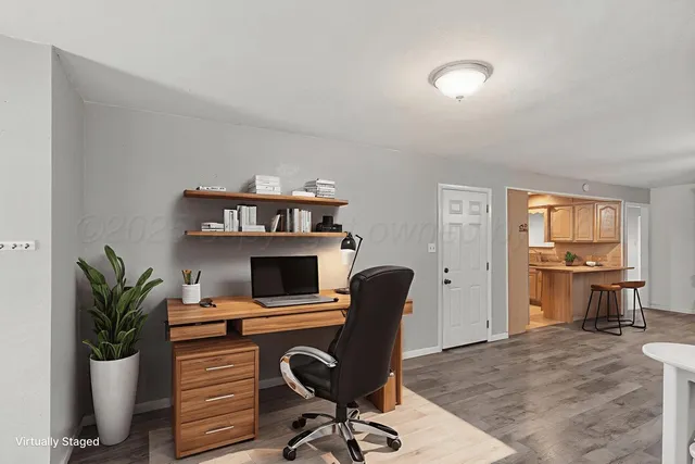 a view of a workspace with furniture and a potted plant