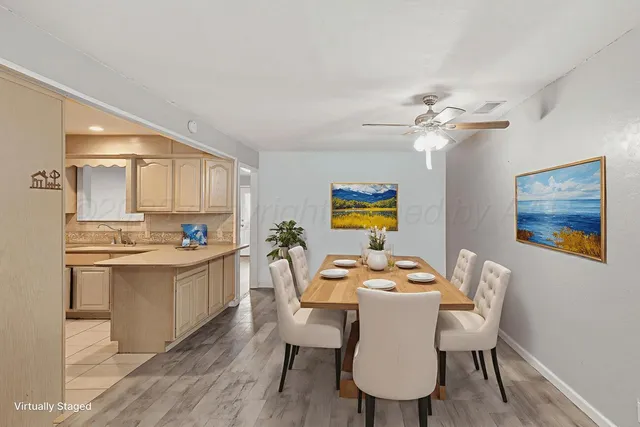 a view of a dining room with furniture a chandelier and wooden floor