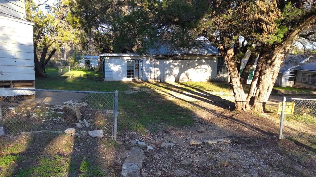 a view of a yard with large trees