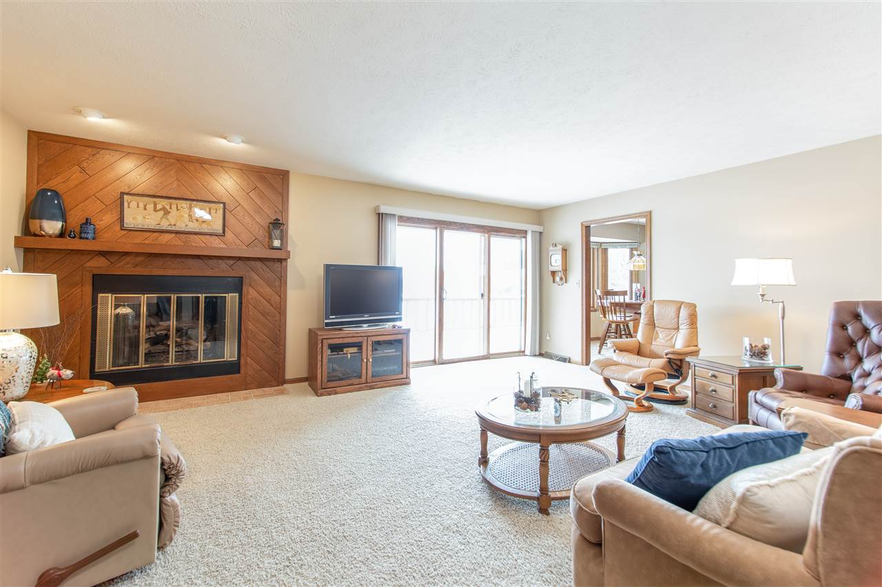 7339 East Wildwood Road Stillman Valley, IL 61084 - Photo 14 of 40 a living room with furniture a fireplace and a flat screen tv
