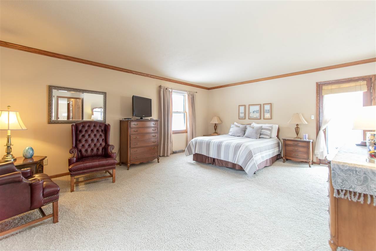 7339 East Wildwood Road Stillman Valley, IL 61084 - Photo 20 of 40 a spacious bedroom with a bed and dresser