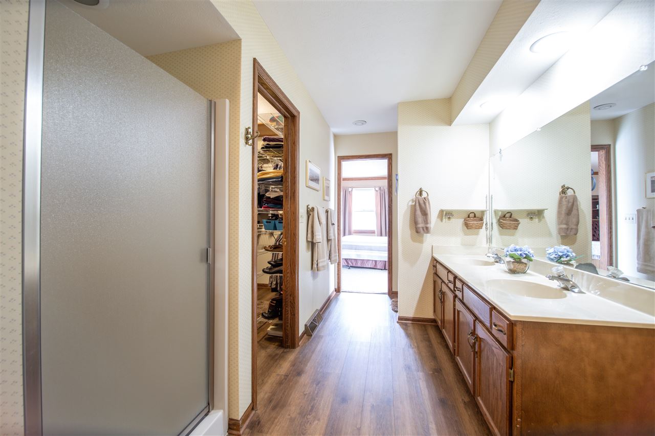 7339 East Wildwood Road Stillman Valley, IL 61084 - Photo 22 of 40 a kitchen with a sink and wooden floor