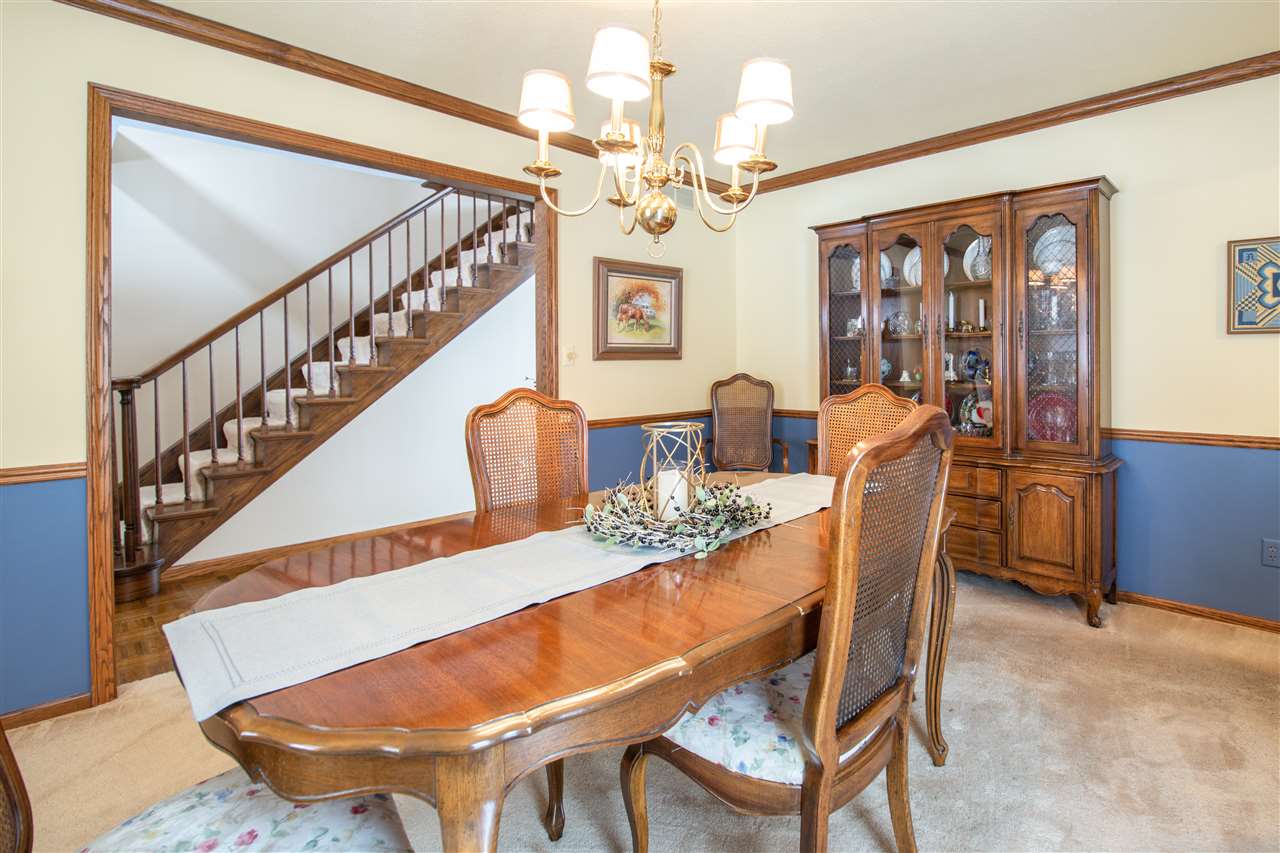 7339 East Wildwood Road Stillman Valley, IL 61084 - Photo 23 of 40 a view of a dining room with furniture a chandelier and wooden floor