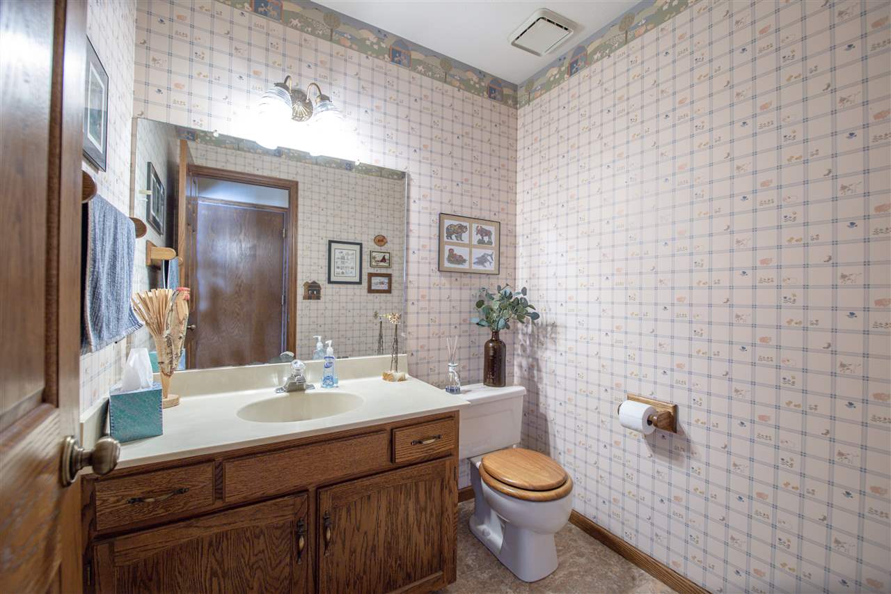 7339 East Wildwood Road Stillman Valley, IL 61084 - Photo 26 of 40 a bathroom with a sink a toilet and mirror