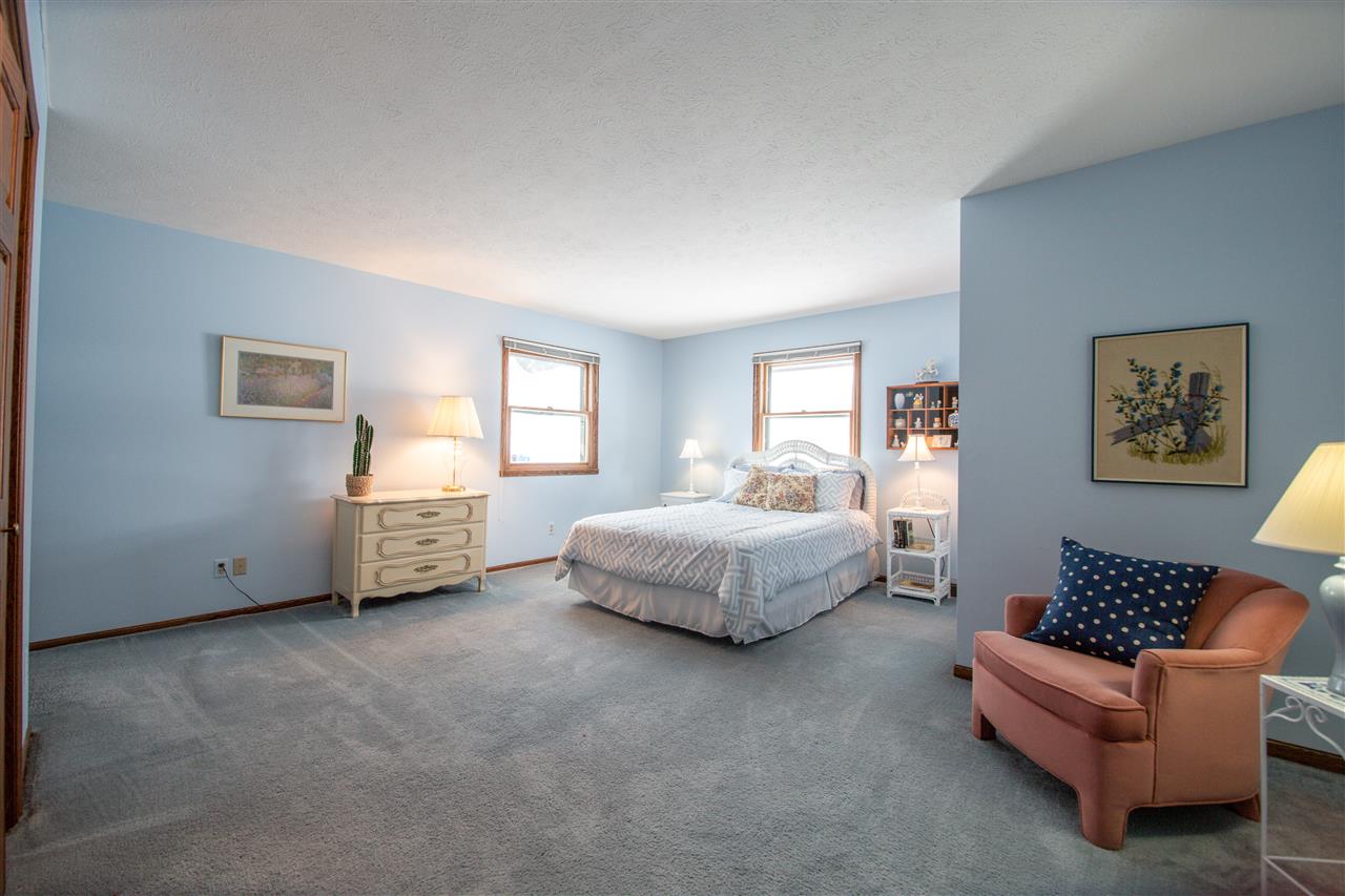 7339 East Wildwood Road Stillman Valley, IL 61084 - Photo 28 of 40 a spacious bedroom with a bed and a couch