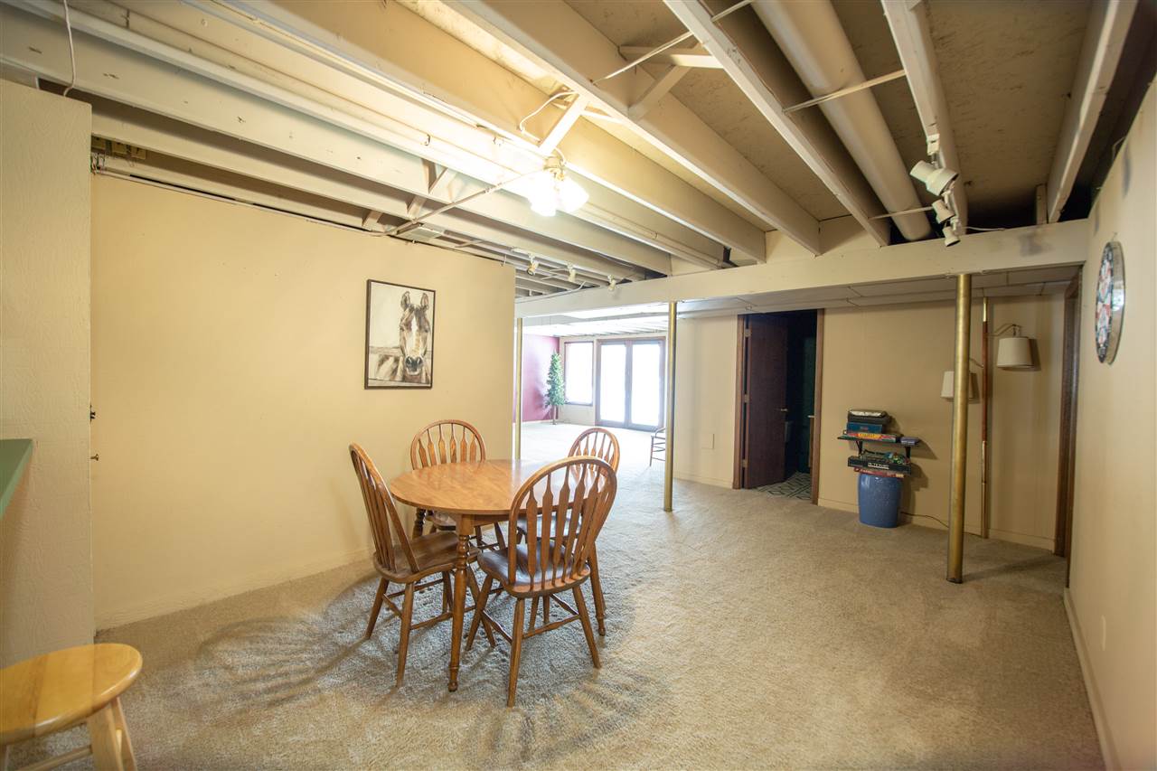7339 East Wildwood Road Stillman Valley, IL 61084 - Photo 32 of 40 a dining room with furniture and a chandelier