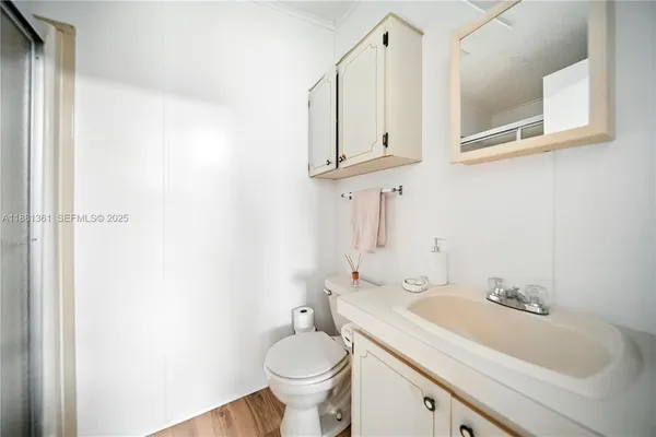 a bathroom with a sink toilet and mirror