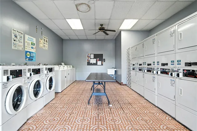 a kitchen with granite countertop a white stove top oven sink and cabinets