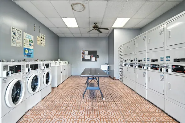 a kitchen with granite countertop a white stove top oven sink and cabinets